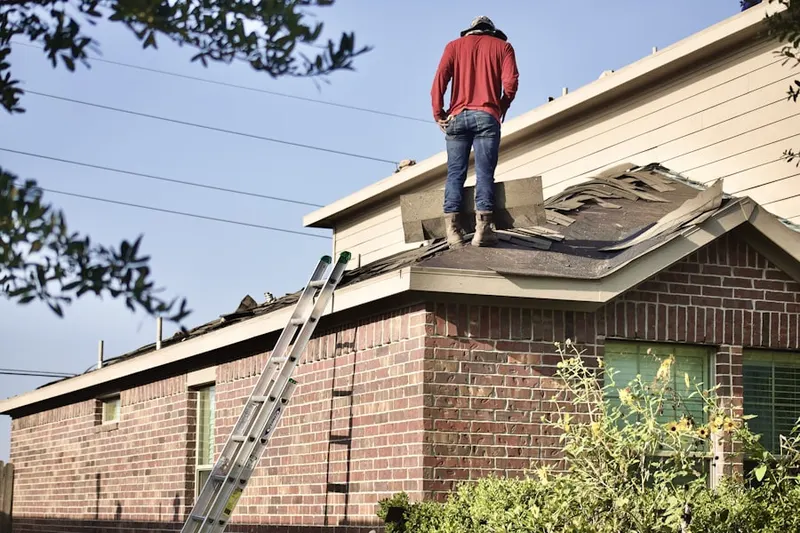 Professional roofer working on a residential roof in Conte Manor